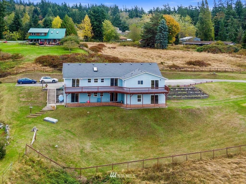 2075 East Goss Lake Road Freeland, WA 98249 - Photo 4 of 40 a view of a swimming pool with a yard and large trees
