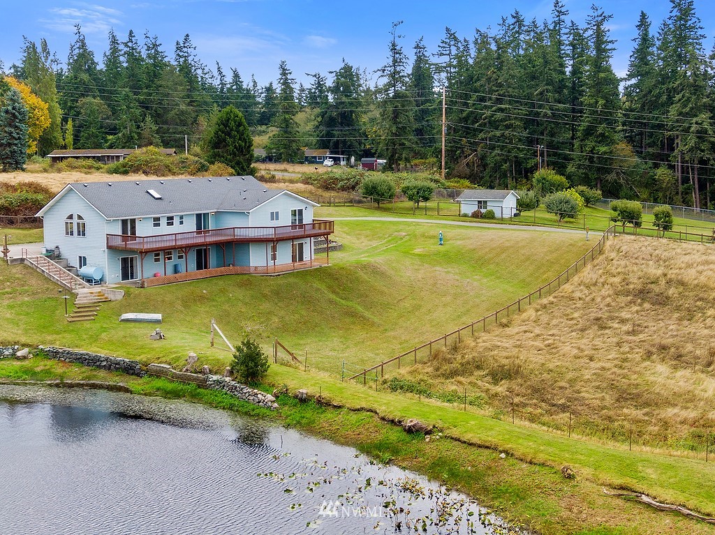 2075 East Goss Lake Road Freeland, WA 98249 - Photo 40 of 40 a view of a lake with a big yard and large trees