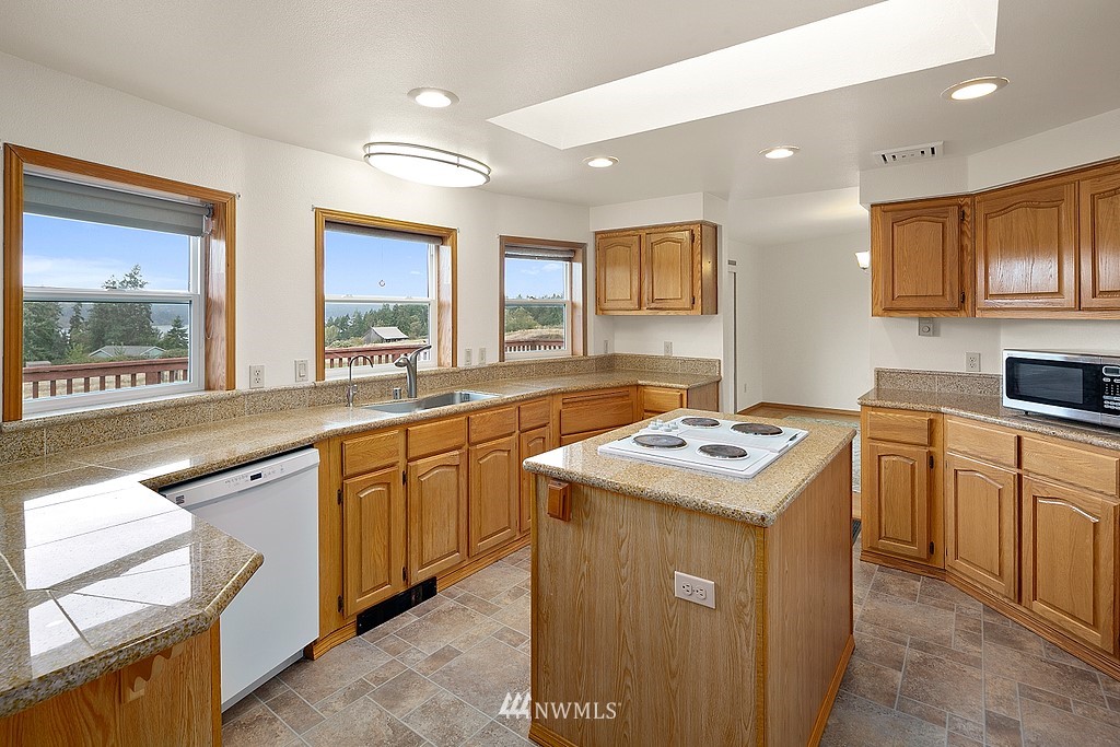 2075 East Goss Lake Road Freeland, WA 98249 - Photo 5 of 40 a kitchen that has a sink and a stove in it