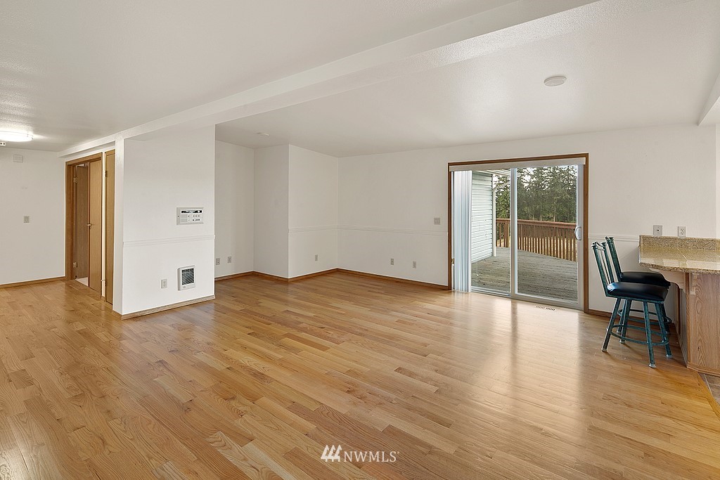 2075 East Goss Lake Road Freeland, WA 98249 - Photo 8 of 40 a view of empty room with wooden floor and fan