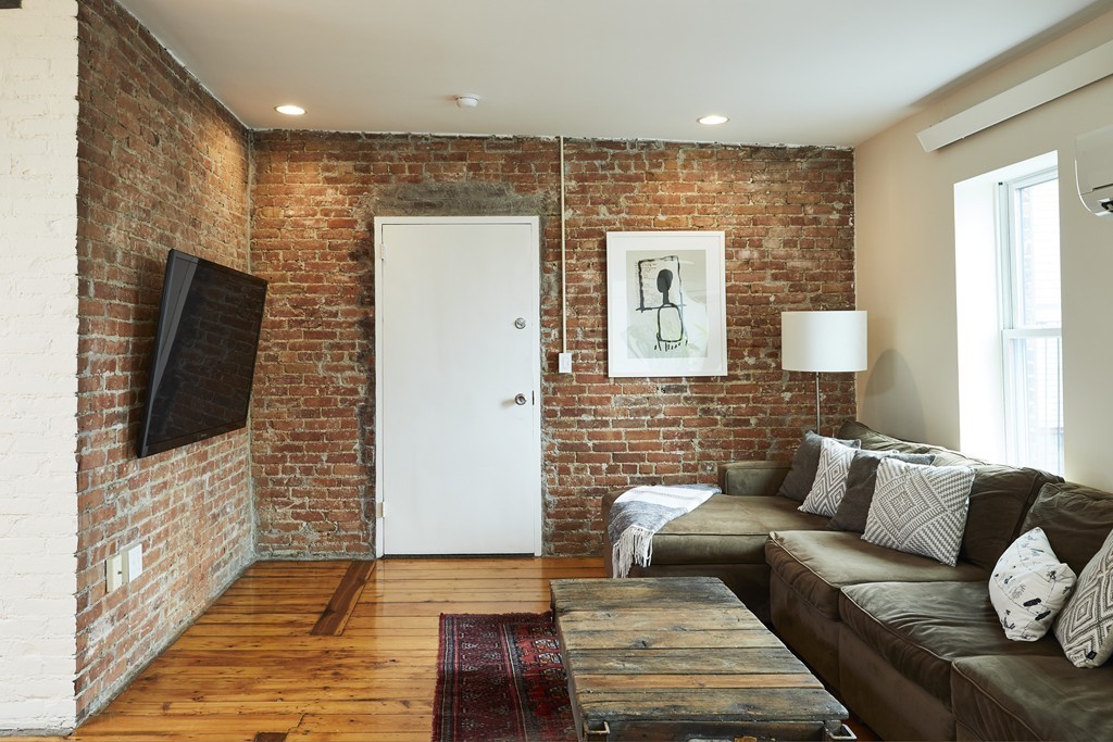 1920 Washington Street, Unit 6 Boston, MA 02118 - Photo 1 of 15 a living room with furniture and a flat screen tv