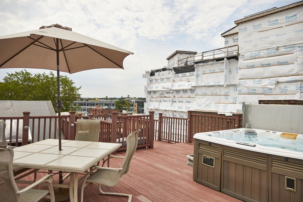 1920 Washington Street, Unit 6 Boston, MA 02118 - Photo 13 of 15 a view of a roof deck with furniture and barbeque oven
