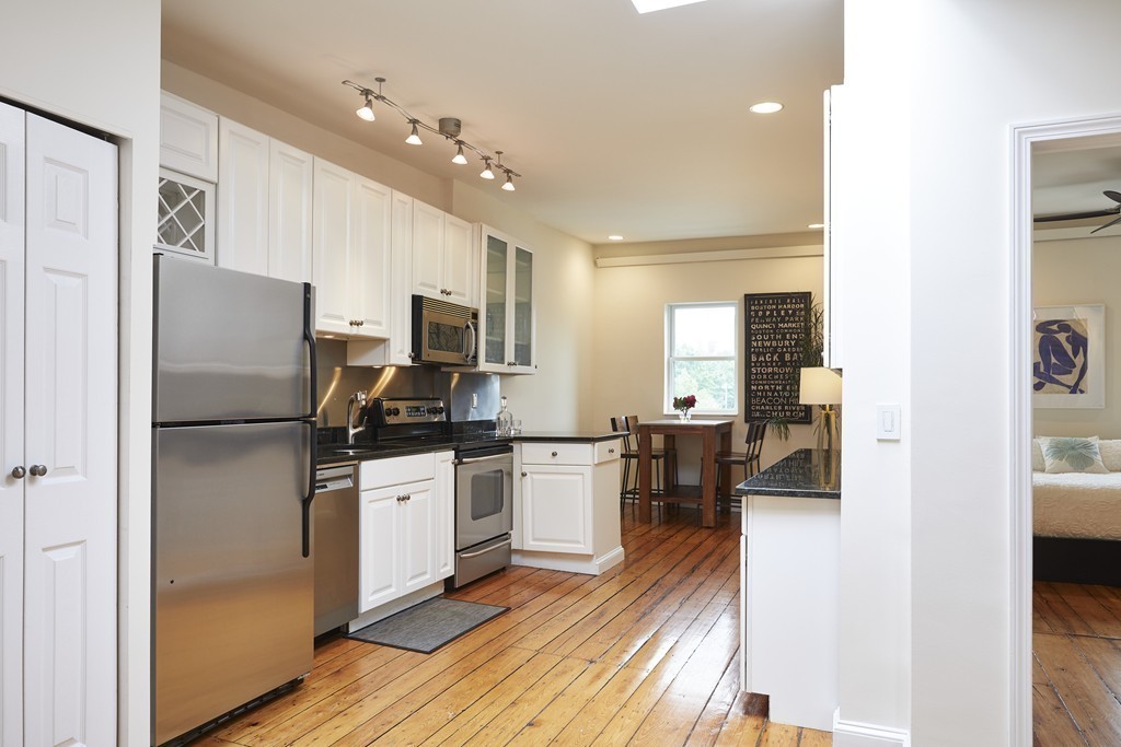 1920 Washington Street, Unit 6 Boston, MA 02118 - Photo 4 of 15 a kitchen with a refrigerator a stove top oven a sink and dishwasher