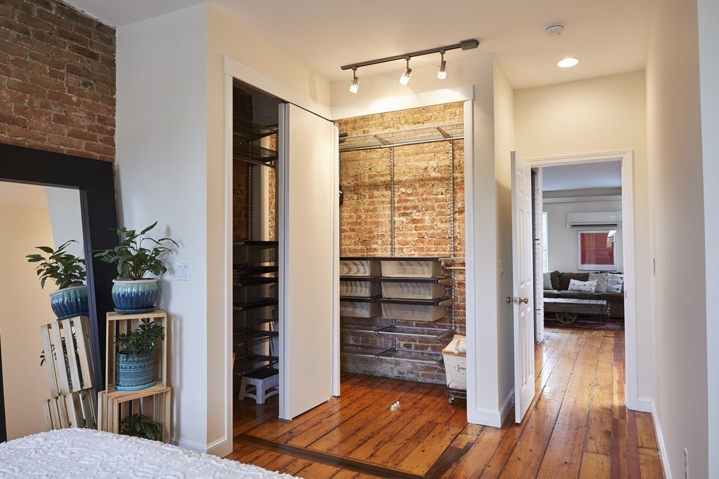 1920 Washington Street, Unit 6 Boston, MA 02118 - Photo 7 of 15 a view of a hallway and a livingroom with wooden floor