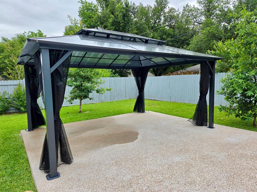 520 Red River Road Belton, TX 76513 - Photo 29 of 36 Outdoor gazebo structure featuring a tiered roof, a gray frame, and black mesh privacy screens
