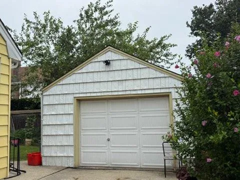 a view of barn house with a large window and large tree