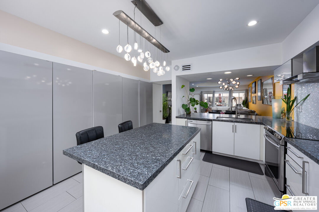 277 East Alejo Road, Unit 124 Palm Springs, CA 92262 - Photo 13 of 25 a kitchen with a sink a counter space and appliances