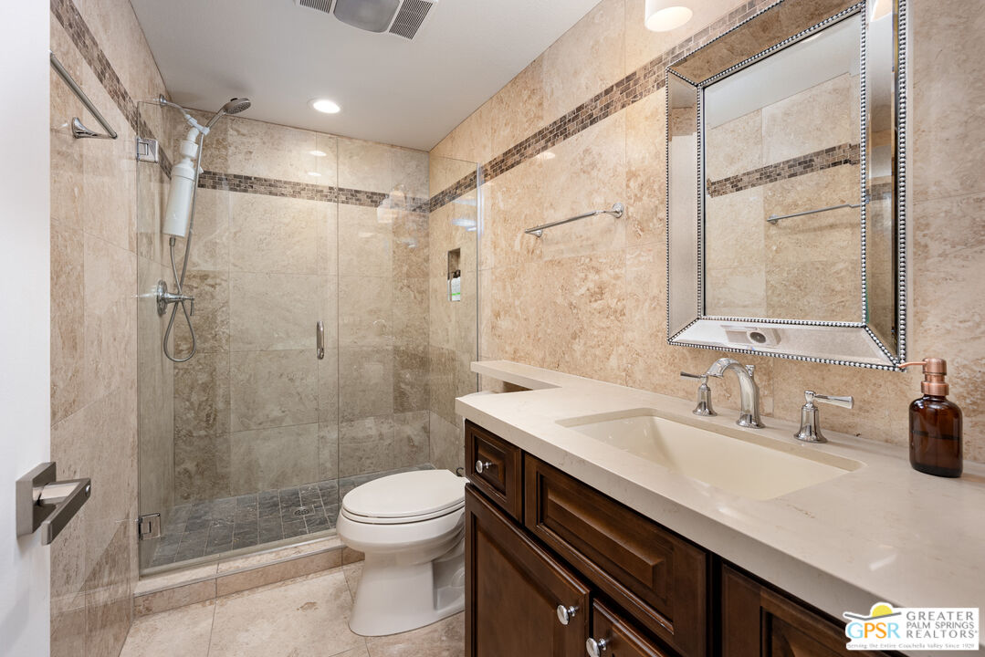 277 East Alejo Road, Unit 124 Palm Springs, CA 92262 - Photo 16 of 25 a bathroom with a sink a toilet and shower
