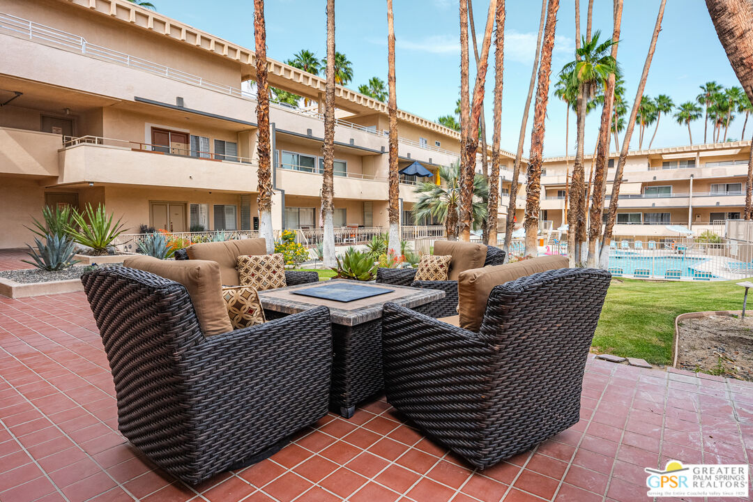 277 East Alejo Road, Unit 124 Palm Springs, CA 92262 - Photo 21 of 25 a view of a patio with couches chairs and a fire pit