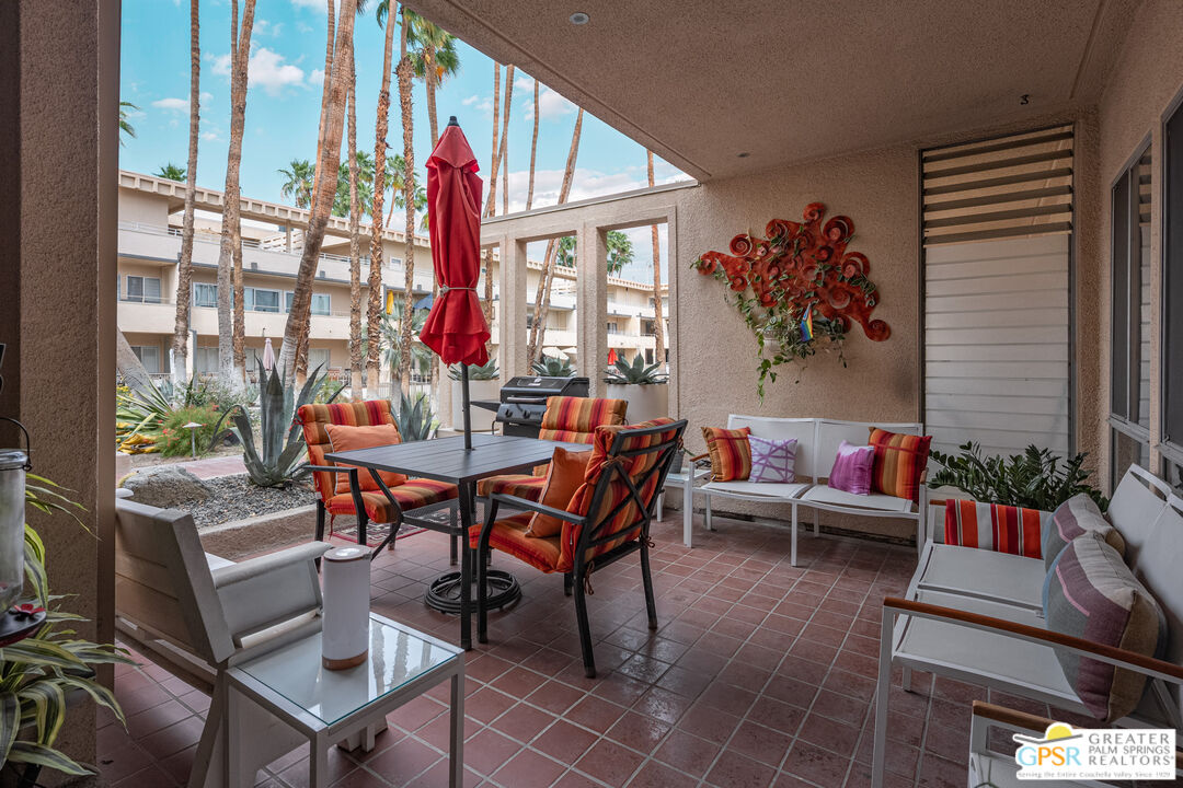 277 East Alejo Road, Unit 124 Palm Springs, CA 92262 - Photo 5 of 25 a living room with furniture and a large window