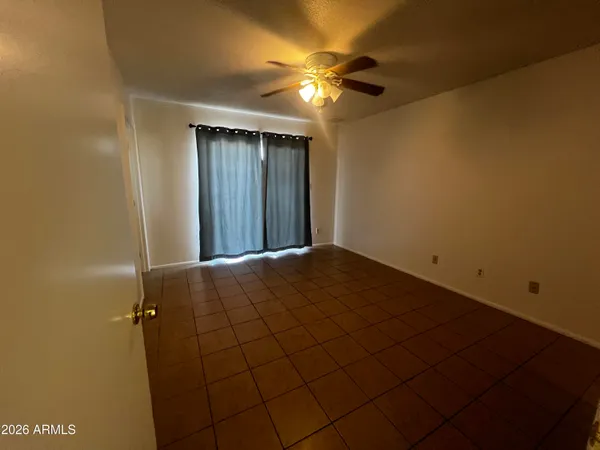 a view of a livingroom with a ceiling fan and closet