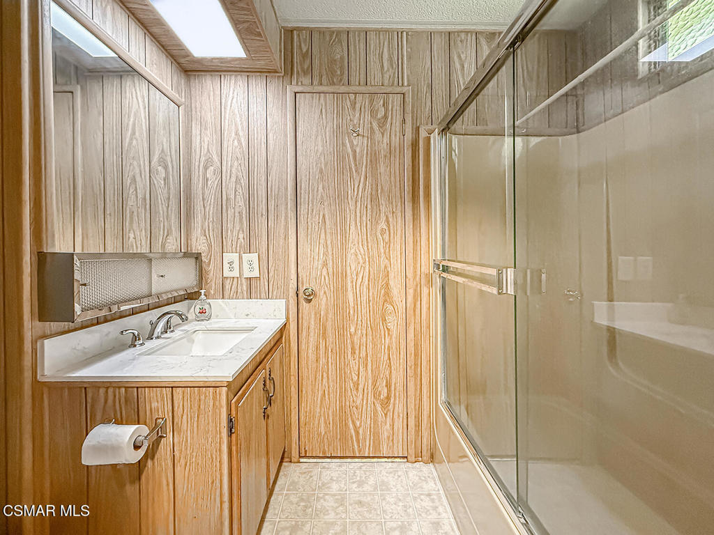 195 Tierra Rejada Road, Unit 116 Simi Valley, CA 93065 - Photo 15 of 36 a bathroom with a sink a mirror and a shower