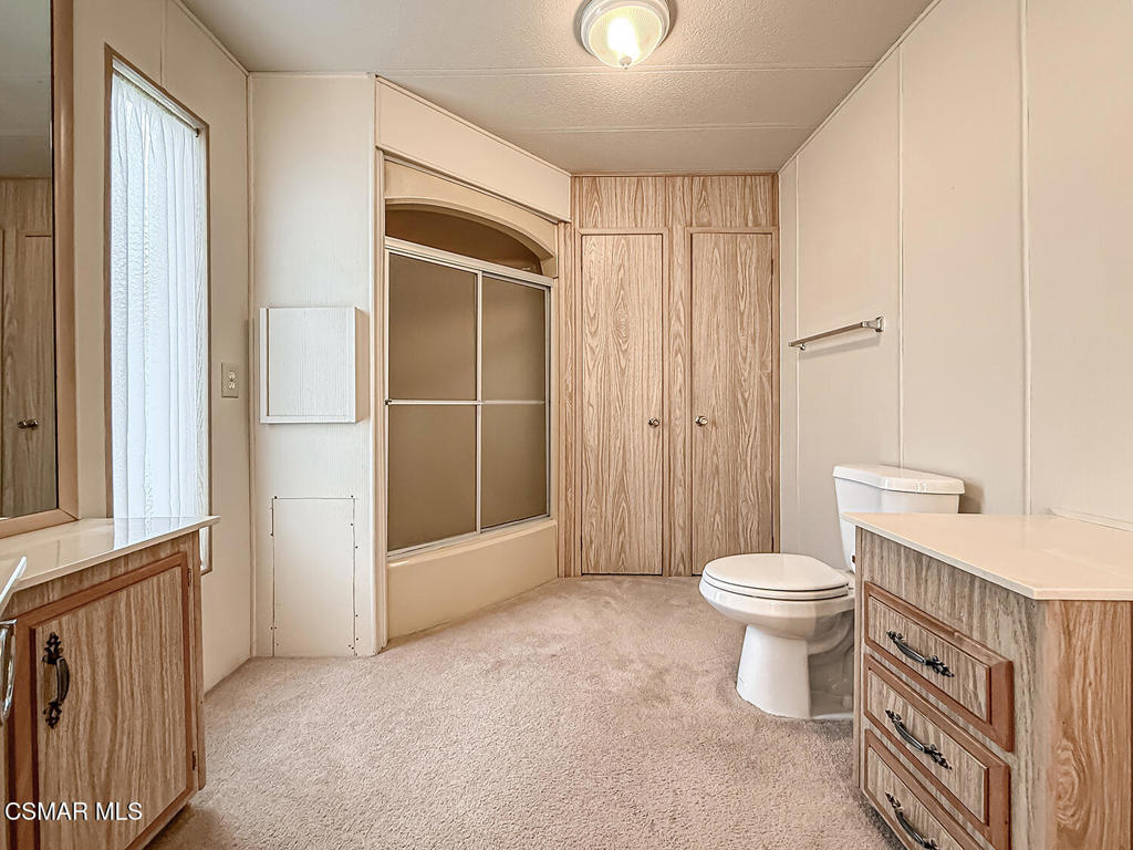 195 Tierra Rejada Road, Unit 116 Simi Valley, CA 93065 - Photo 19 of 36 a bathroom with a toilet a sink and shower