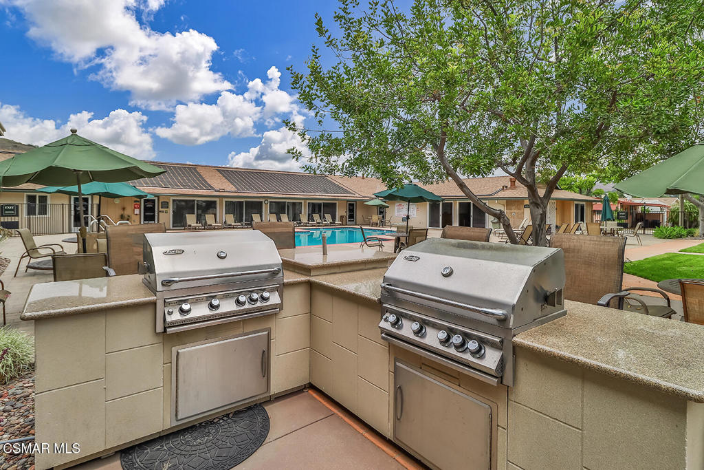 195 Tierra Rejada Road, Unit 116 Simi Valley, CA 93065 - Photo 30 of 36 a kitchen with stove and cabinets