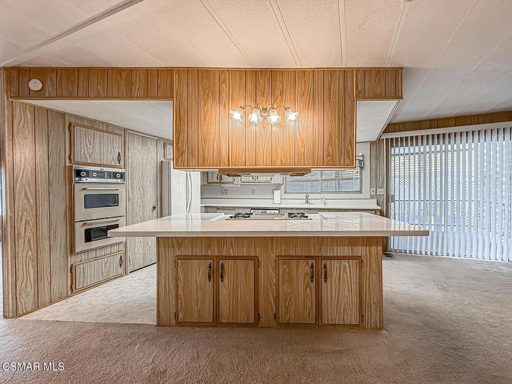 195 Tierra Rejada Road, Unit 116 Simi Valley, CA 93065 - Photo 8 of 36 a kitchen with stainless steel appliances granite countertop a stove a sink and a refrigerator