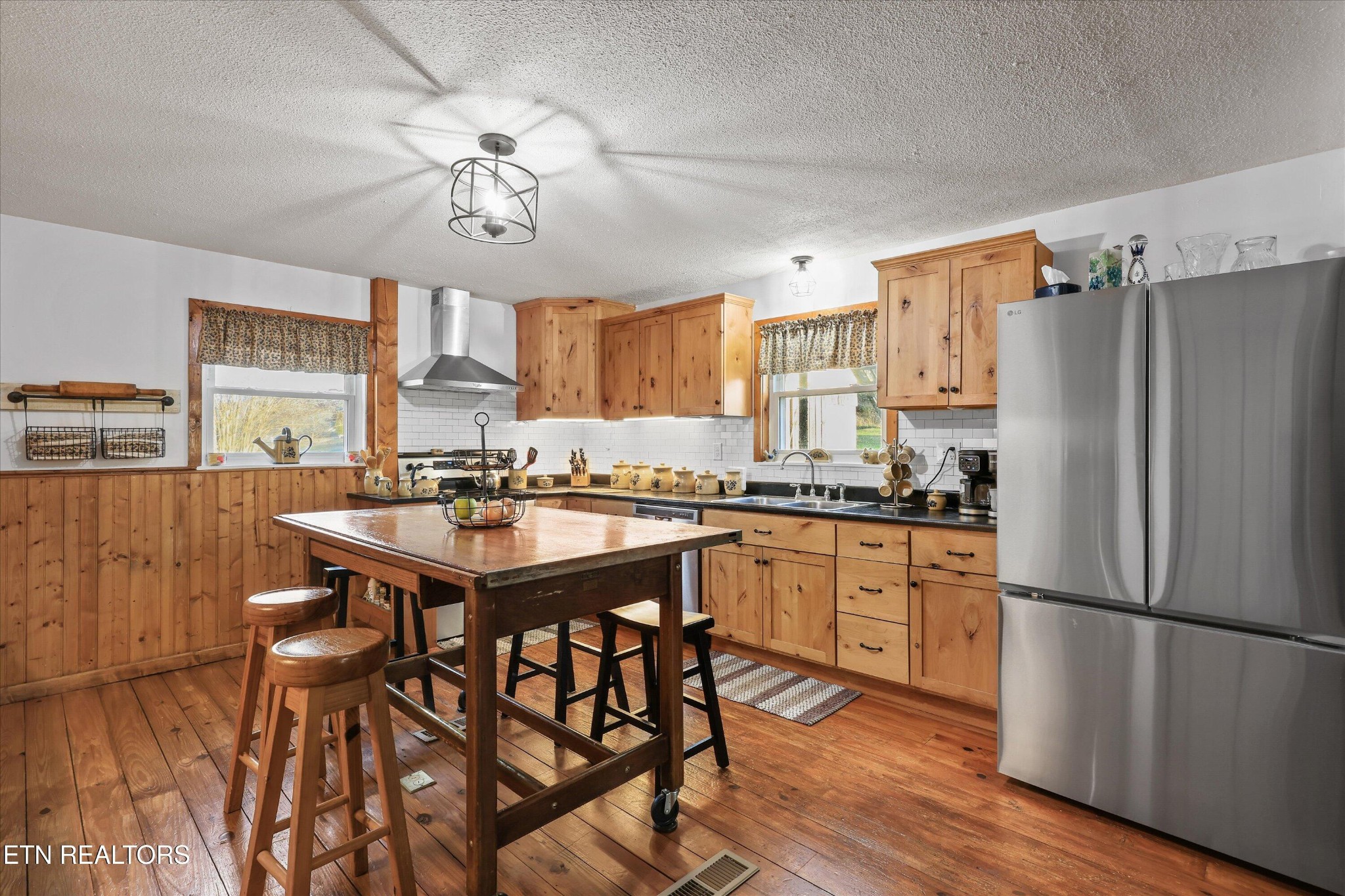 7969 Glendale Community Road Greenback, TN 37742 - Photo 22 of 56 a kitchen with stainless steel appliances granite countertop a dining table and chairs