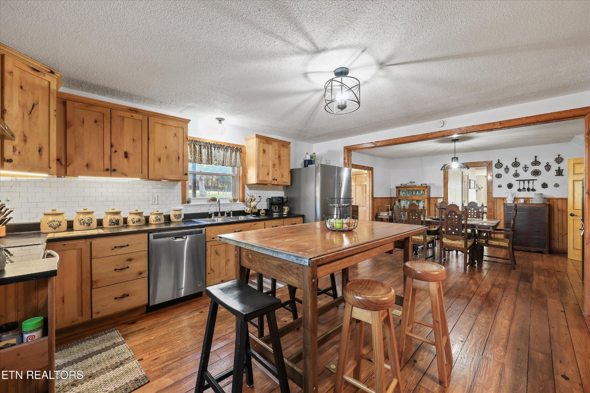 7969 Glendale Community Road Greenback, TN 37742 - Photo 23 of 56 a kitchen with stainless steel appliances granite countertop a stove top oven a sink dishwasher and chairs with wooden floor