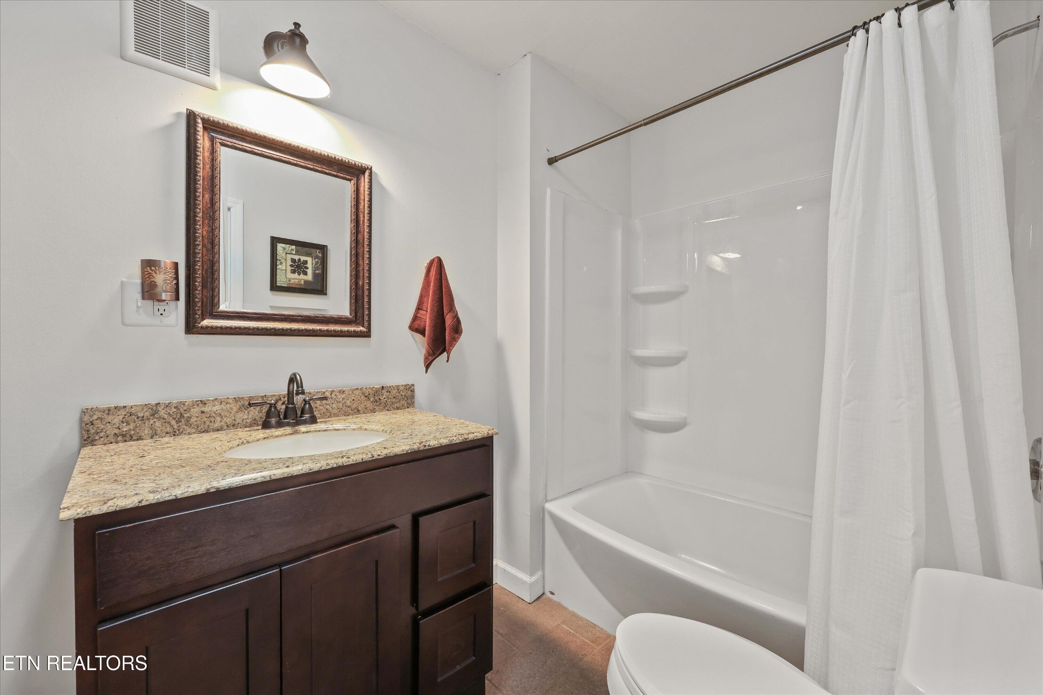 7969 Glendale Community Road Greenback, TN 37742 - Photo 31 of 56 a bathroom with a granite countertop sink toilet and shower
