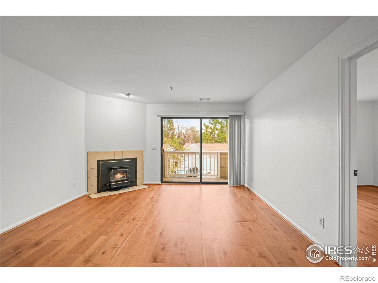 4945 Twin Lakes Road, Unit 39 Boulder, CO 80301 - Photo 3 of 22 a view of an empty room with a fireplace and a window