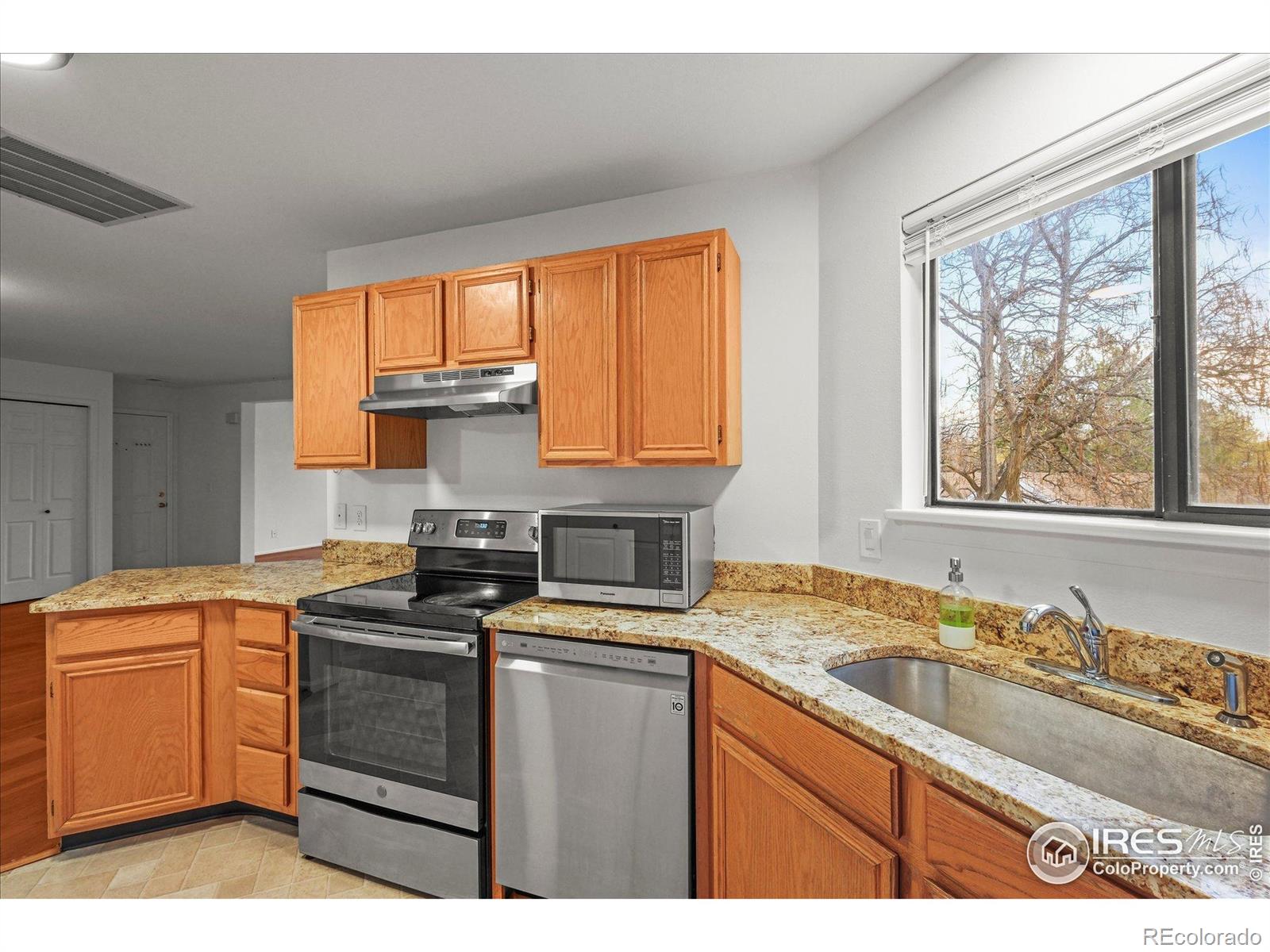 4945 Twin Lakes Road, Unit 39 Boulder, CO 80301 - Photo 9 of 22 a kitchen with granite countertop a sink stove top oven and cabinets