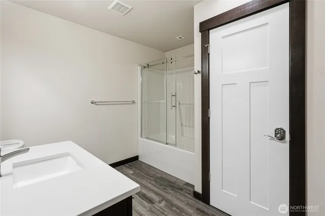 a bathroom with a sink vanity and a mirror