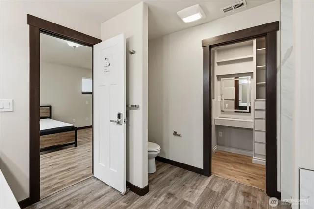 a view of a room with wooden floor