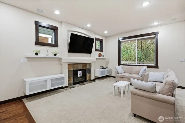 a living room with furniture a flat screen tv and a fireplace