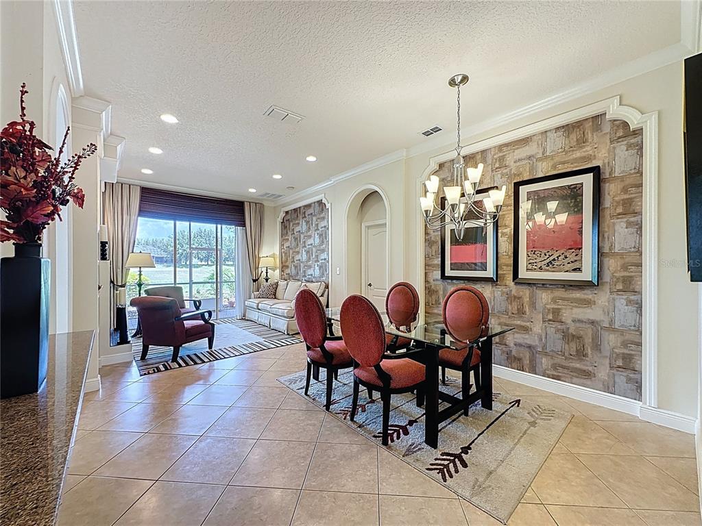 243 Bayou Bend Road Groveland, FL 34736 - Photo 11 of 77 a view of a dining room with furniture a chandelier and window