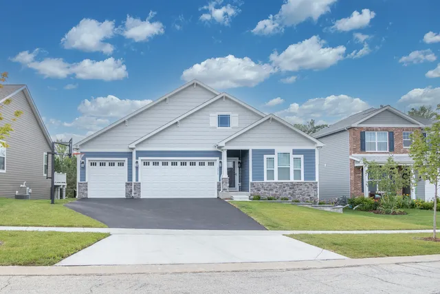 a front view of a house with a yard and garage