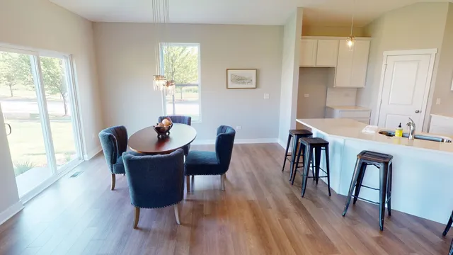 a dining room with furniture window and wooden floor