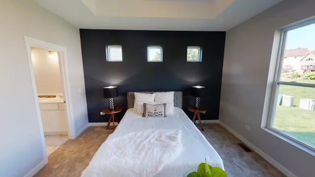 a view of a bedroom with furniture and wooden floor
