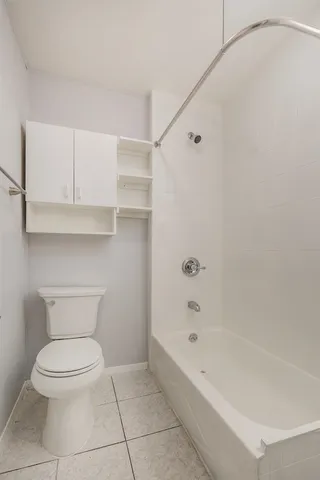 a bathroom with a toilet and a bathtub
