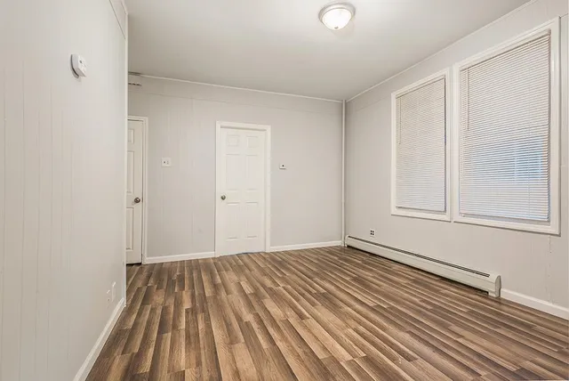 a view of a room with wooden floor and cabinet