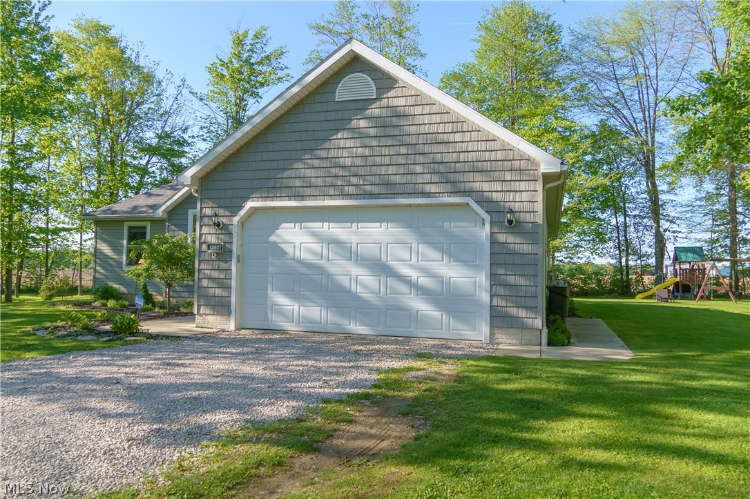 1362 Apollo Court Rome, OH 44085 - Photo 29 of 32 Garage featuring a yard