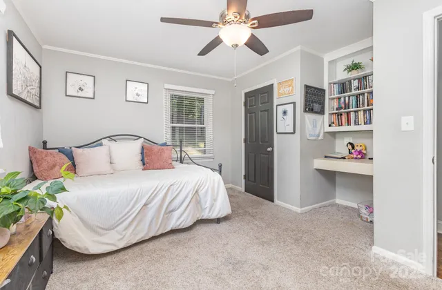 a bedroom with a bed and ceiling fan