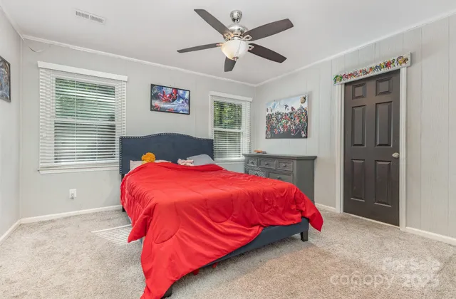 a bedroom with a bed and a chandelier