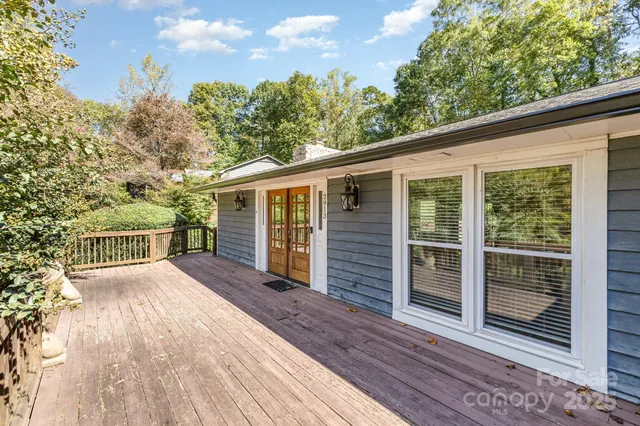 a view of a house with a wooden deck