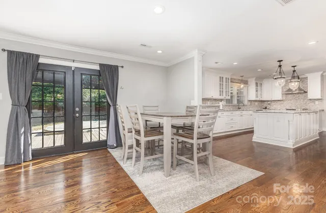 a view of a dining room kitchen and hall with wooden floor