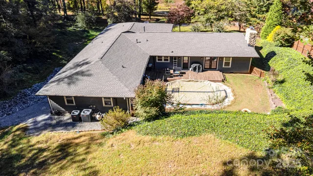 a aerial view of a house with table and chairs under an umbrella