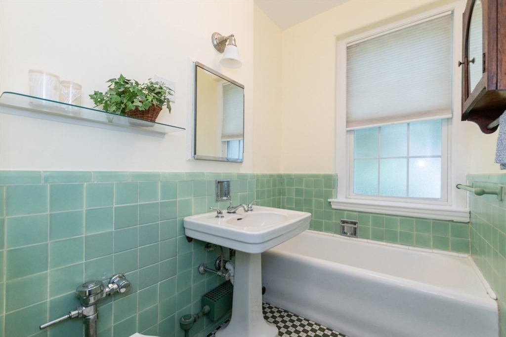 63 Babcock Street, Unit B1 Brookline, MA 02446 - Photo 24 of 32 a bathroom with a sink a toilet and shower