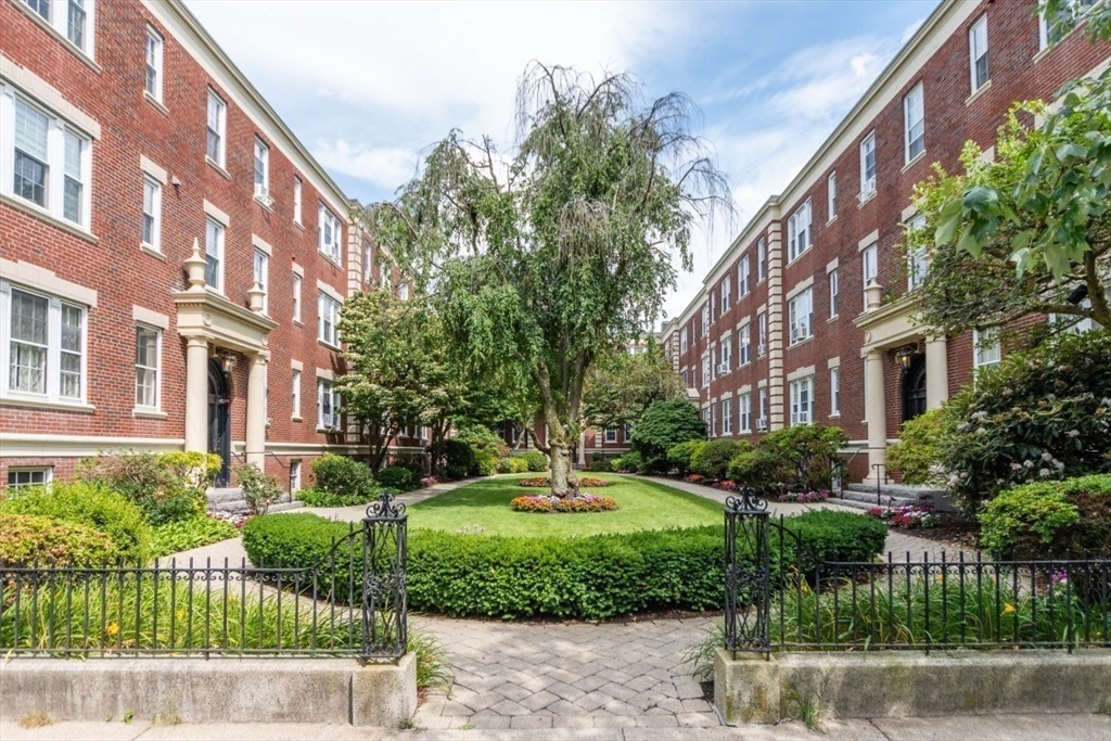 63 Babcock Street, Unit B1 Brookline, MA 02446 - Photo 29 of 32 a view of a building with a yard