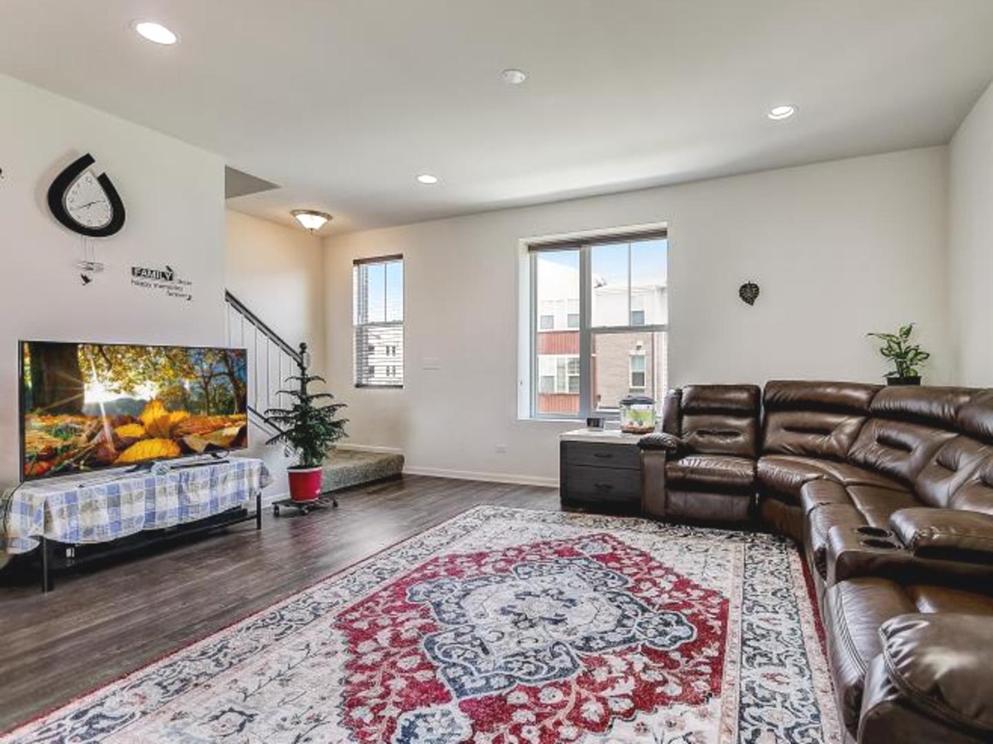 4156 Irving Road Aurora, IL 60504 - Photo 8 of 28 a living room with furniture and a flat screen tv