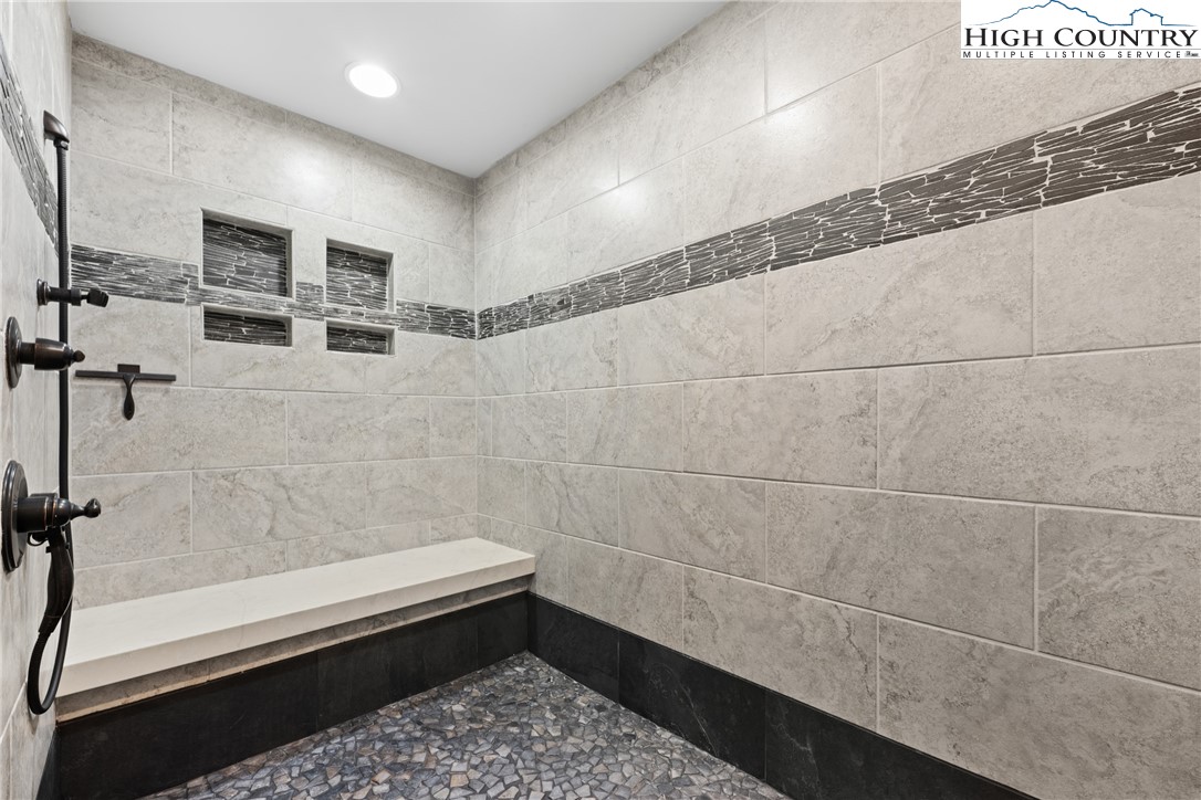 299 Edgewood Path Blowing Rock, NC 28605 - Photo 13 of 39 a bathroom with a bathtub and a shower