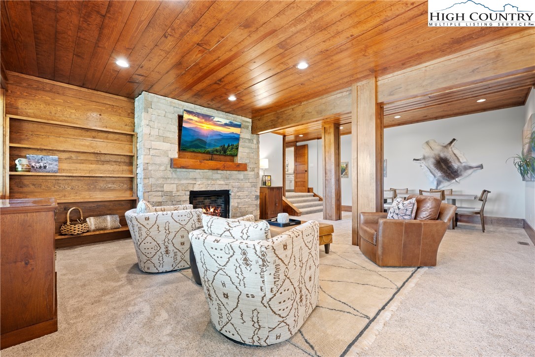 299 Edgewood Path Blowing Rock, NC 28605 - Photo 14 of 39 a living room with furniture and a flat screen tv