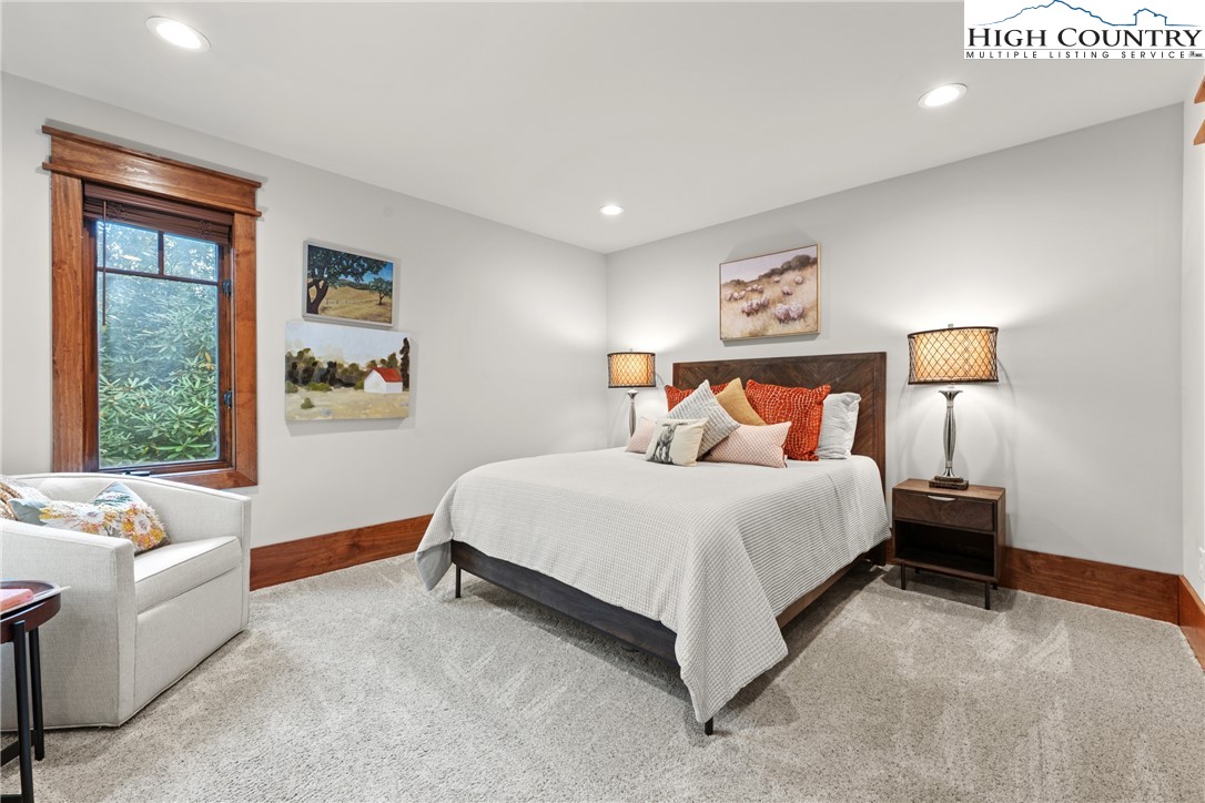 299 Edgewood Path Blowing Rock, NC 28605 - Photo 19 of 39 a bed room with a bed and a couch