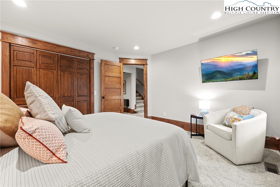 299 Edgewood Path Blowing Rock, NC 28605 - Photo 20 of 39 a bedroom with a bed and a couch