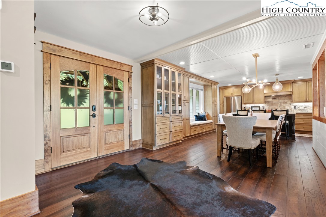 299 Edgewood Path Blowing Rock, NC 28605 - Photo 2 of 39 a view of a dining room with furniture window and wooden floor