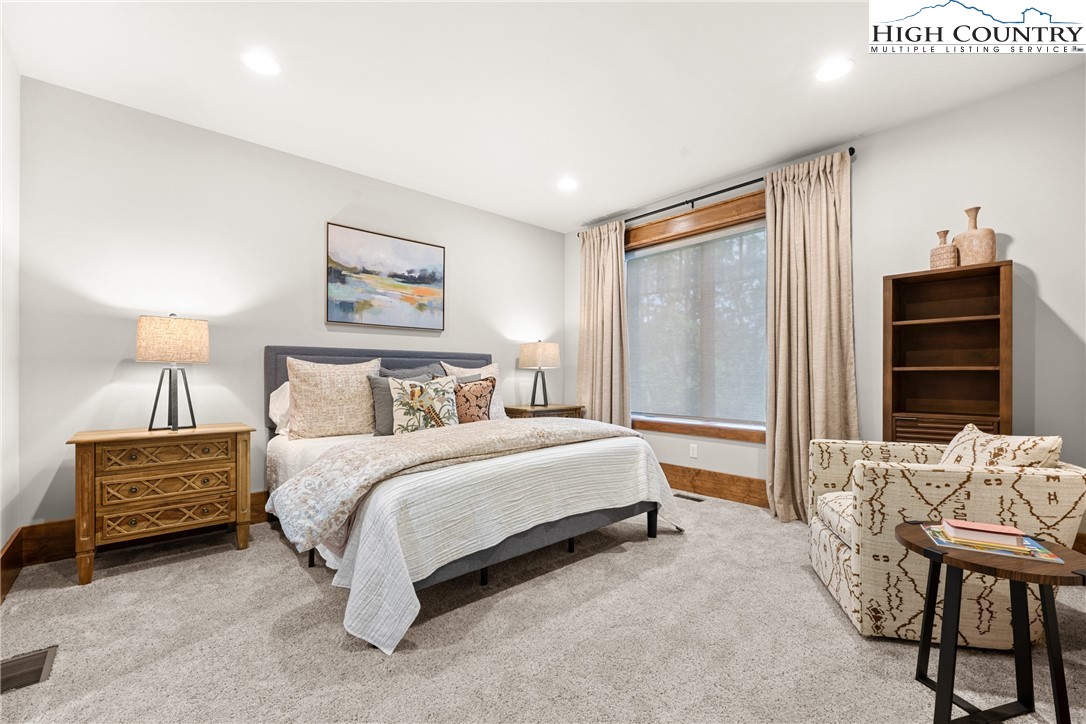299 Edgewood Path Blowing Rock, NC 28605 - Photo 23 of 39 a spacious bedroom with a bed and a walk in closet