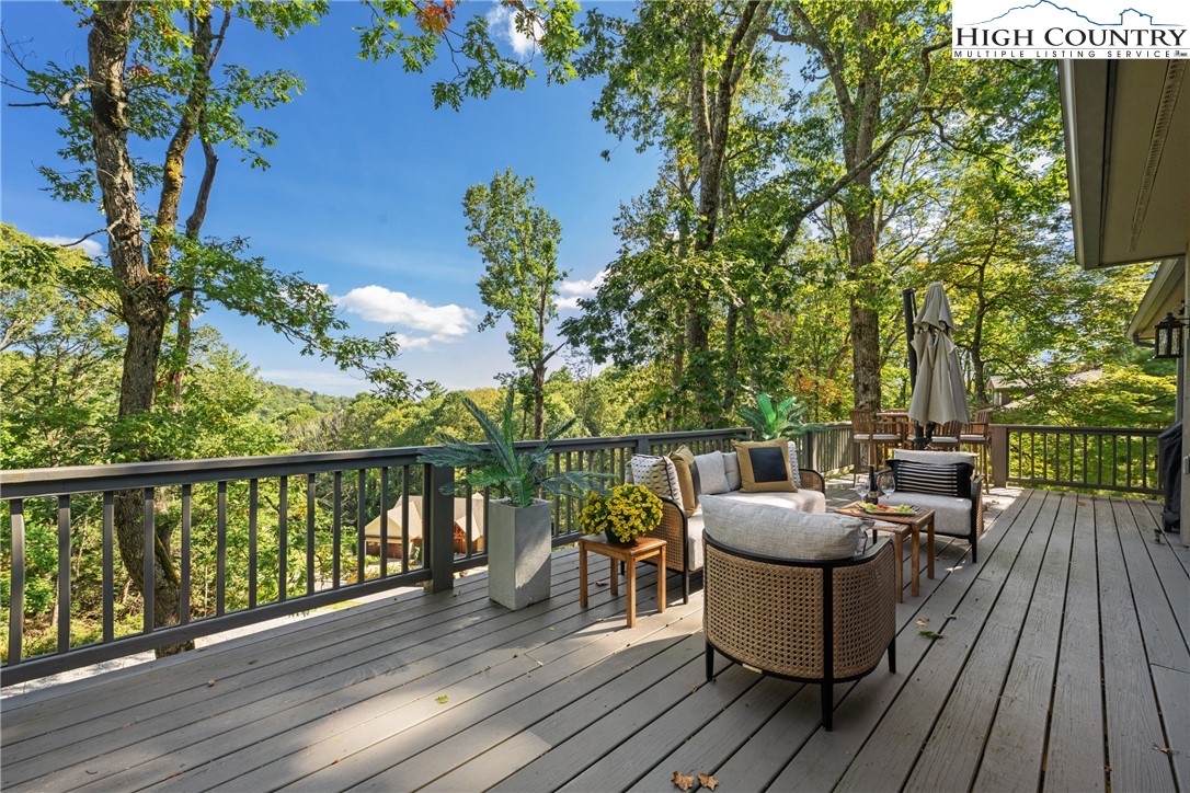 299 Edgewood Path Blowing Rock, NC 28605 - Photo 26 of 39 a balcony with wooden floor table and chairs
