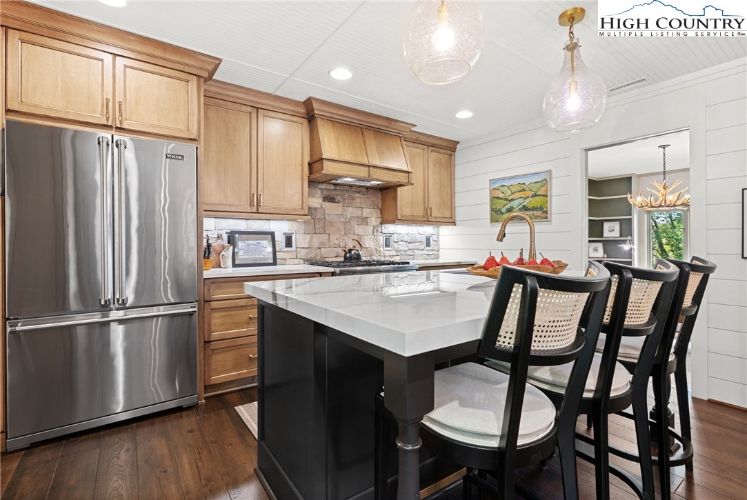 299 Edgewood Path Blowing Rock, NC 28605 - Photo 3 of 39 a kitchen with a table chairs refrigerator and cabinets